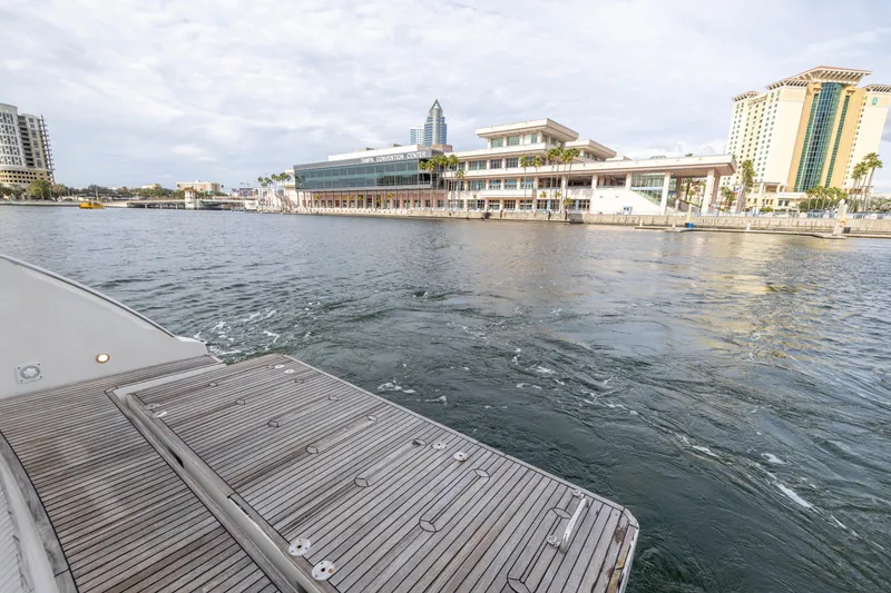 Slide: The Image of 2012 Azimut 48 Flybridge yacht docked near waterfront buildings. - 12