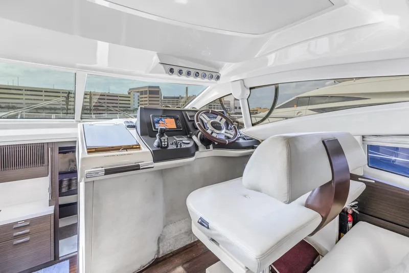 Slide: The Image of Cockpit of 2012 Azimut 48 Flybridge yacht with modern controls and white leather seating. - 17