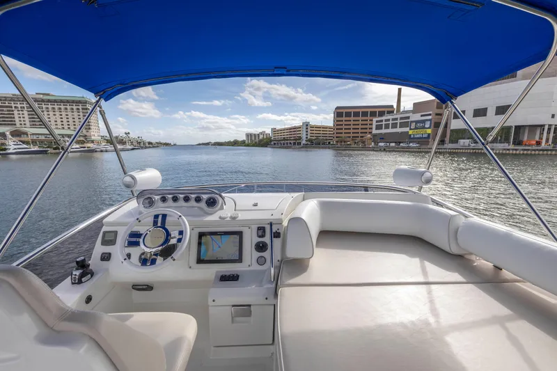 Slide: The Image of 2012 Azimut 48 Flybridge yacht helm with blue canopy, city waterfront view. - 41