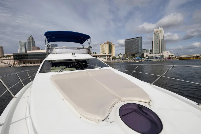 Slide: The Image of 2012 Azimut 48 Flybridge yacht docked with city skyline in the background. - 5