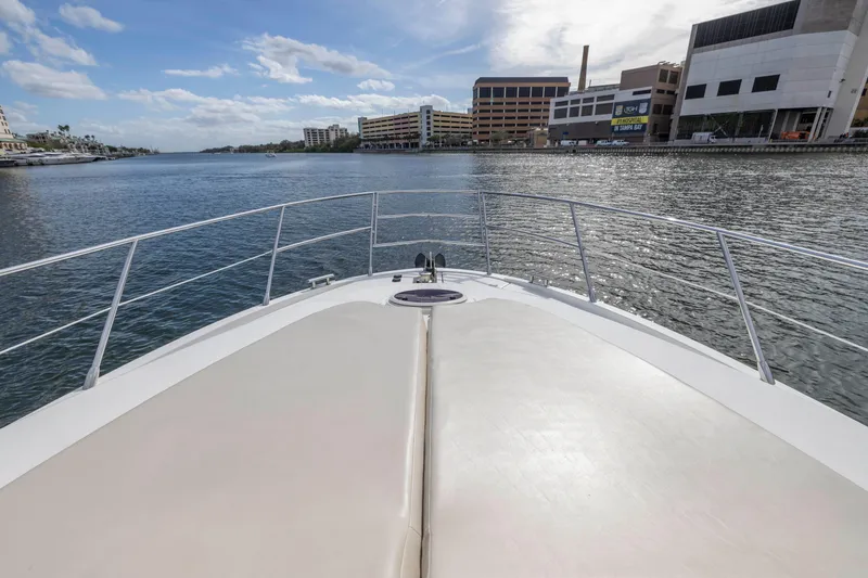 Slide: The Image of Bow view of 2012 Azimut 48 Flybridge yacht on calm waters near urban buildings. - 8