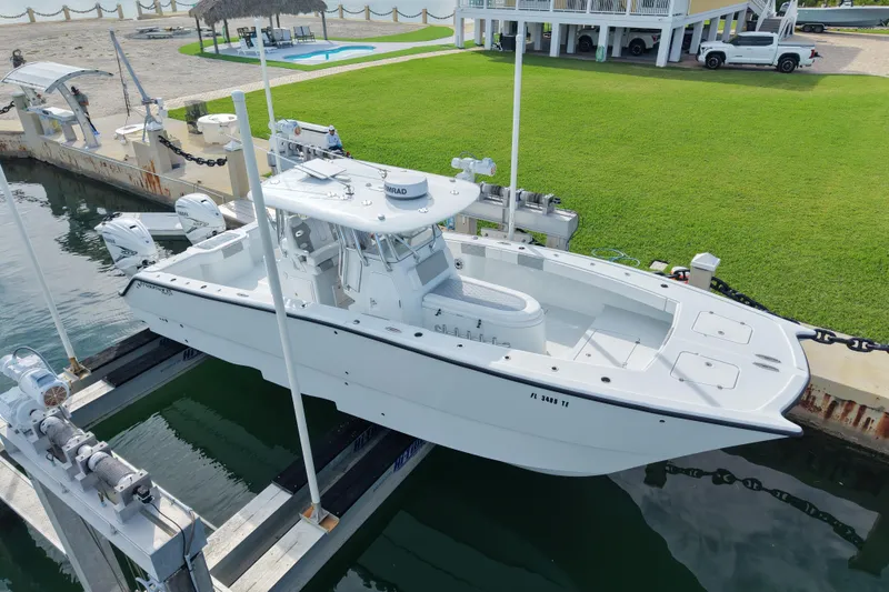 The Image of Freeman 34VH 2022 boat docked at marina with lush green lawn background. - 0