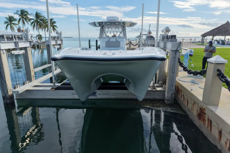 Slide: The Image of 2022 Freeman 34VH boat on lift by tropical waterfront with palm trees. - 16