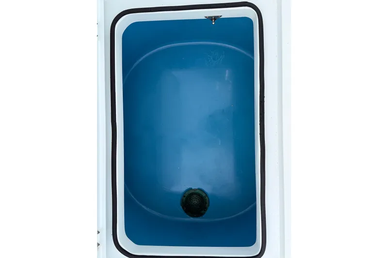 Slide: The Image of Freeman 34VH 2022 boat livewell with blue interior and drain plug. - 19