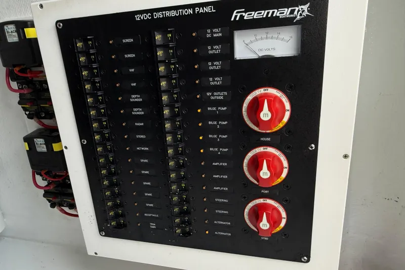 Slide: The Image of 12VDC distribution panel on 2022 Freeman 34VH boat, featuring switches and voltage meter. - 22