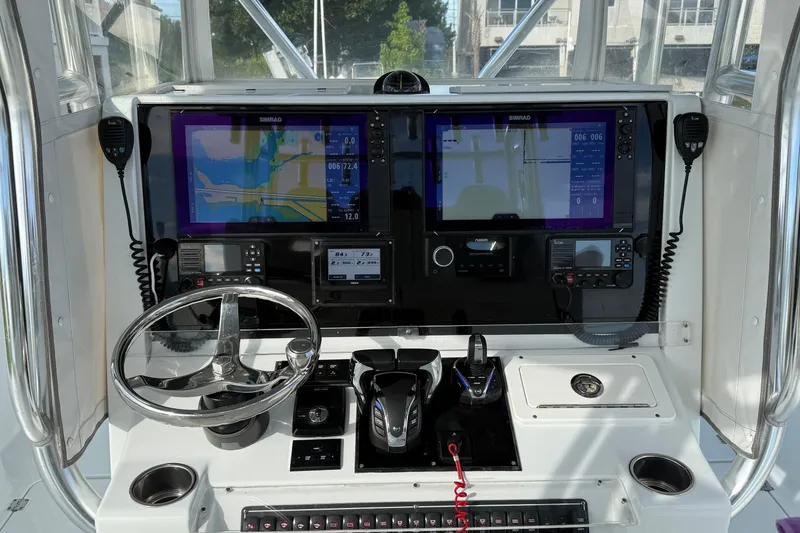 Slide: The Image of Control panel of a 2022 Freeman 34VH boat with navigation screens and steering wheel. - 23
