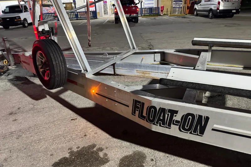 Slide: The Image of Trailer with "FLOAT-ON" branding, Freeman 34VH model, 2022, parked in a lot at night. - 29