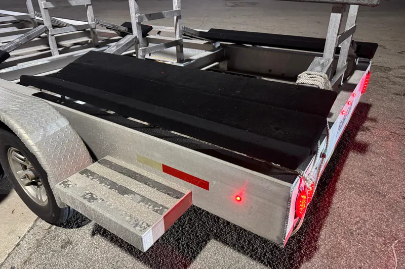 Slide: The Image of Aluminum trailer with black padding and red lights, Freeman 34VH, 2022 model. - 30