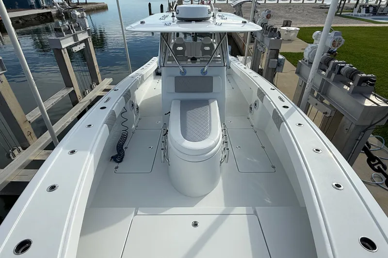 Slide: The Image of 2022 Freeman 34VH boat docked, showcasing spacious deck and seating area. - 6