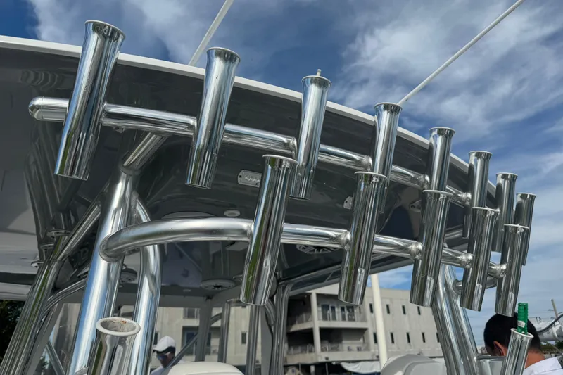 Slide: The Image of Stainless steel rod holders on a 2022 Freeman 34VH boat under a blue sky. - 9