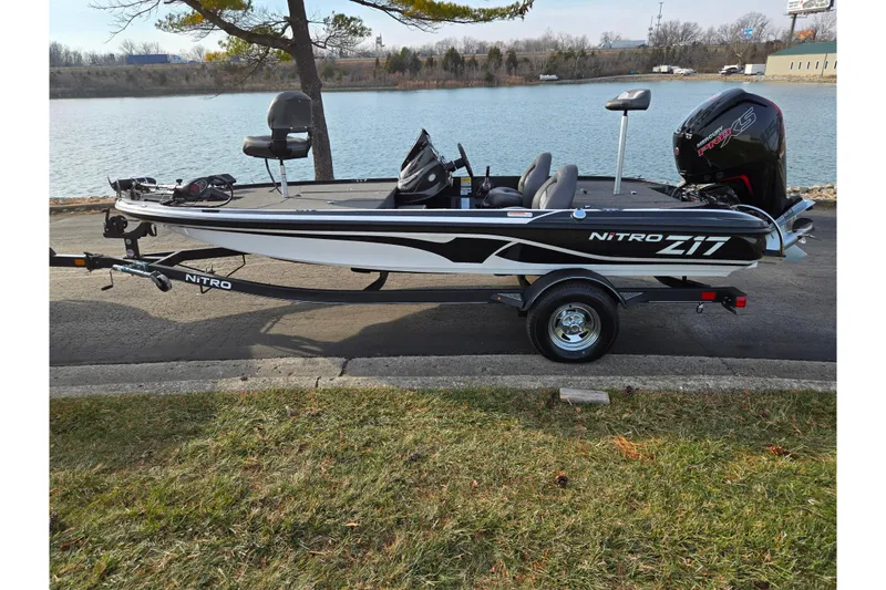 Slide: The Image of 2020 Nitro Z17 boat on trailer by a lake, featuring sleek design and powerful engine. - 10