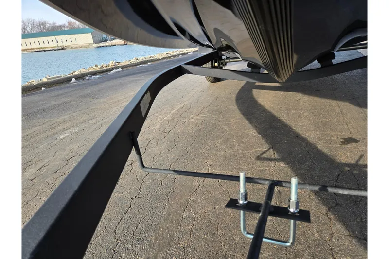 Slide: The Image of 2020 Nitro Z17 boat trailer on a lakeside pavement, showcasing undercarriage details. - 7