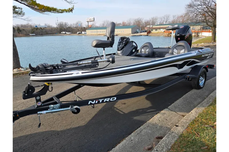 Slide: The Image of 2020 Nitro Z17 boat on trailer by a lake, featuring sleek design and MotorGuide trolling motor. - 9