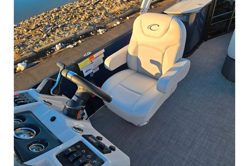 Slide: The Image of Captain's seat of 2022 Crest Classic LX 220 boat with control panel and steering wheel. - 12