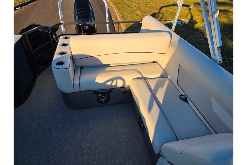 Slide: The Image of 2022 Crest Classic LX 220 boat interior with beige seating and cup holders. - 14