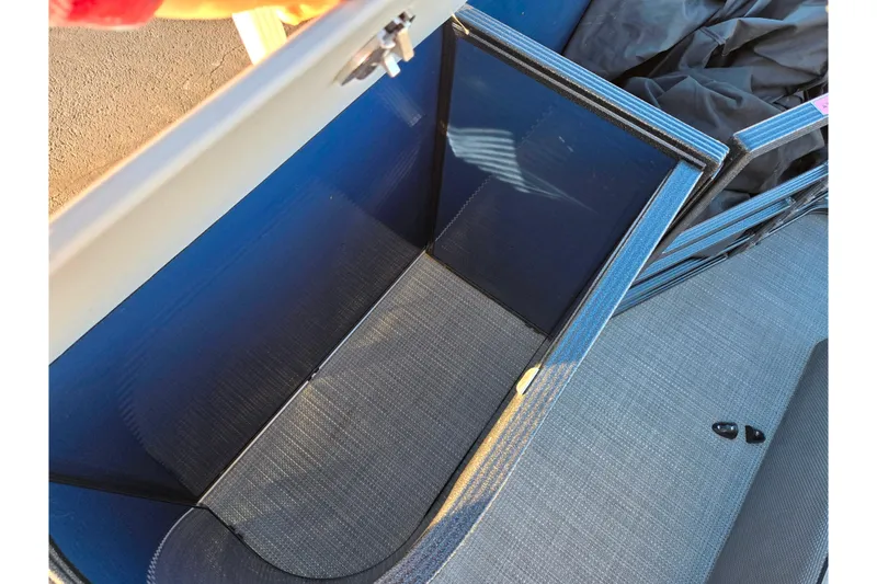 Slide: The Image of Open storage compartment in 2022 Crest Classic LX 220 boat interior. - 16