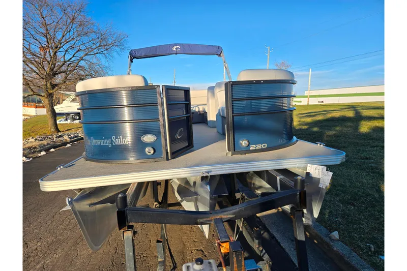 Slide: The Image of 2022 Crest Classic LX 220 pontoon boat on trailer, parked outdoors. - 6
