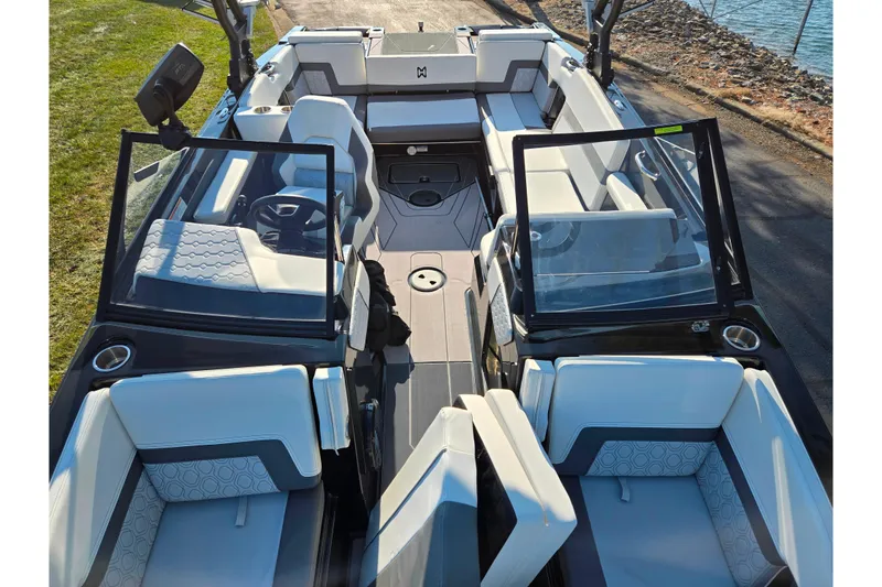 Slide: The Image of 2023 Heyday H22 boat interior with modern seating and sleek design near water. - 18