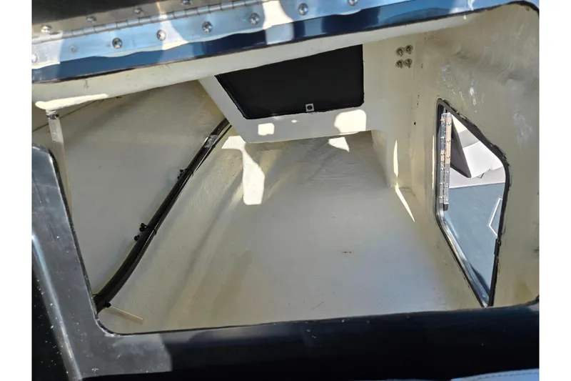 Slide: The Image of Interior cabin of 2023 Heyday H22 boat, featuring white walls and a window. - 24
