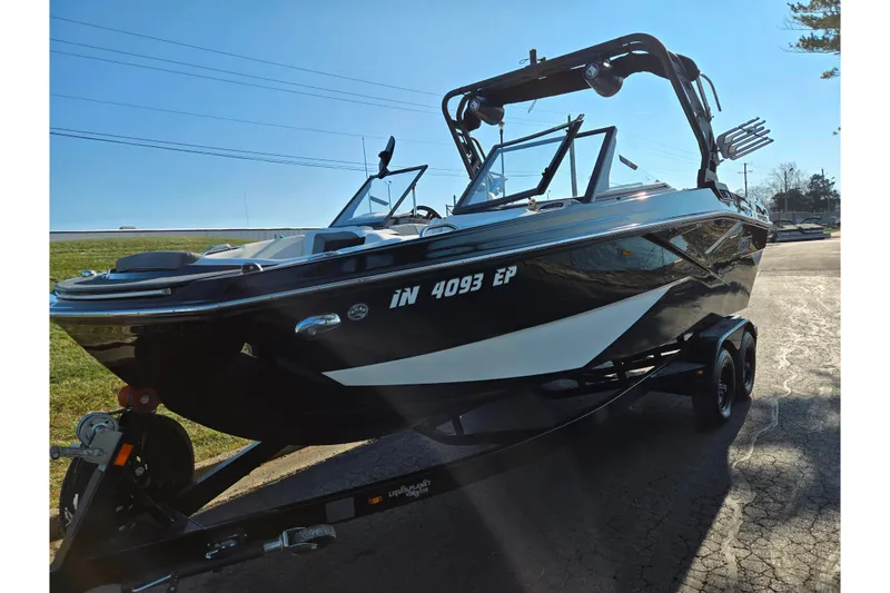 Slide: The Image of 2023 Heyday H22 boat on trailer, sleek black design, sunny day background. - 5