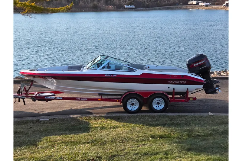 The Image of 1998 Stratos 290 Ski-N-Fish boat on trailer by a lake. - 0
