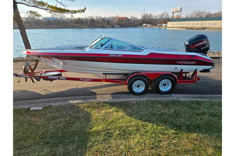 Slide: The Image of 1998 Stratos 290 Ski-N-Fish boat on trailer by a lakeside. - 10