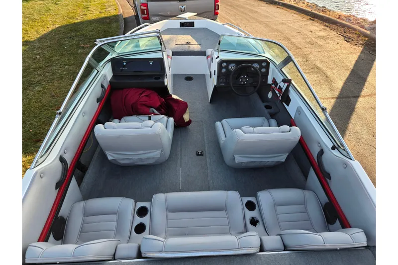 Slide: The Image of 1998 Stratos 290 Ski-N-Fish boat interior with gray seating and dashboard view. - 11