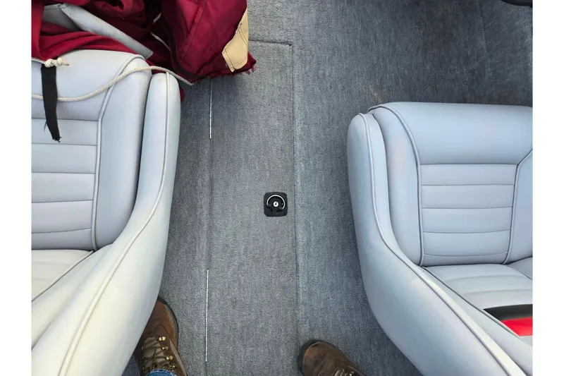 Slide: The Image of 1998 Stratos 290 Ski-N-Fish boat interior with gray seats and carpet. - 12