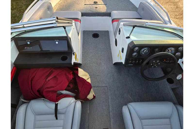 Slide: The Image of 1998 Stratos 290 Ski-N-Fish boat interior with steering wheel and seating. - 14