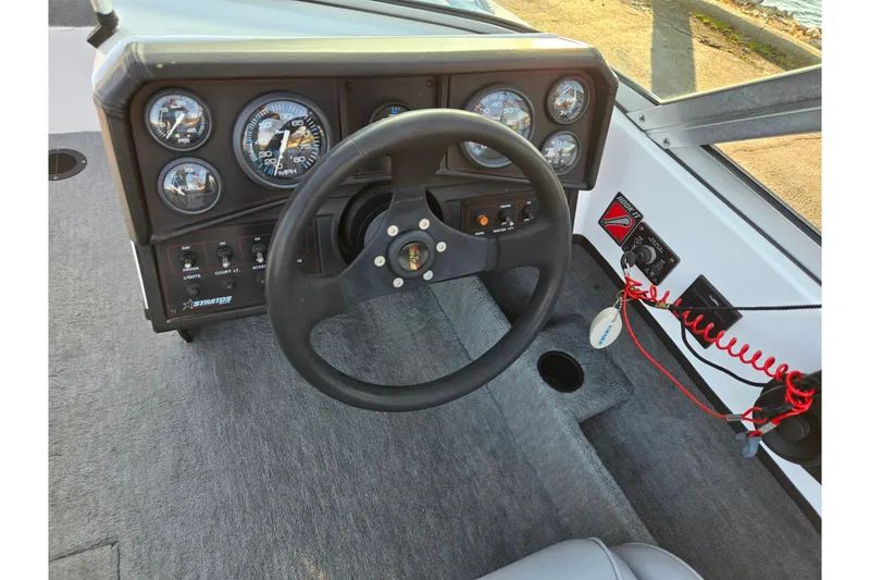 Slide: The Image of 1998 Stratos 290 Ski-N-Fish boat dashboard with steering wheel and instrument panel. - 15
