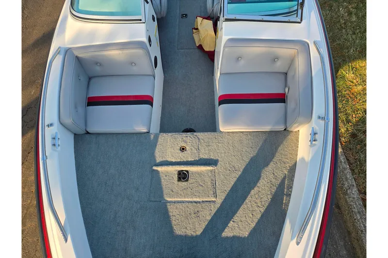 Slide: The Image of 1998 Stratos 290 Ski-N-Fish boat interior with cushioned seating and carpeted floor. - 20