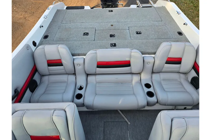 Slide: The Image of 1998 Stratos 290 Ski-N-Fish boat interior with gray and red seating, cup holders, and storage. - 23