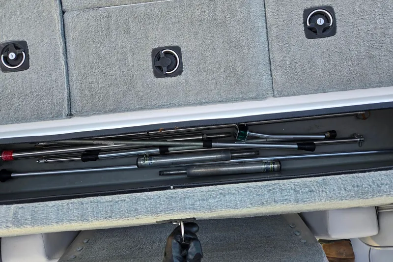 Slide: The Image of Storage compartment with fishing rods in a 1998 Stratos 290 Ski-N-Fish boat. - 24