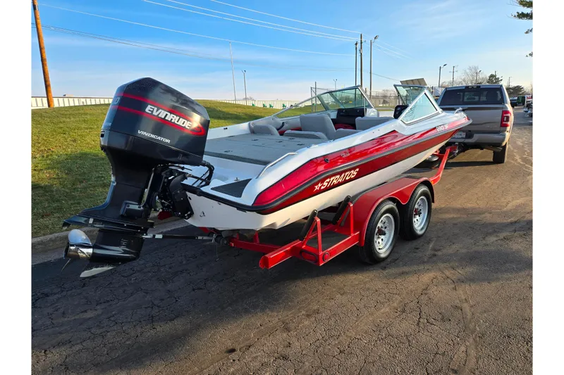 Slide: The Image of 1998 Stratos 290 Ski-N-Fish boat on trailer with Evinrude outboard motor. - 3