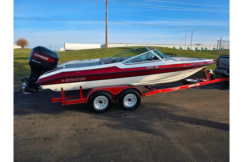 Slide: The Image of 1998 Stratos 290 Ski-N-Fish boat on red trailer, parked outdoors. - 4