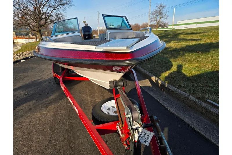 Slide: The Image of 1998 Stratos 290 Ski-N-Fish boat on trailer, parked outdoors on a sunny day. - 6
