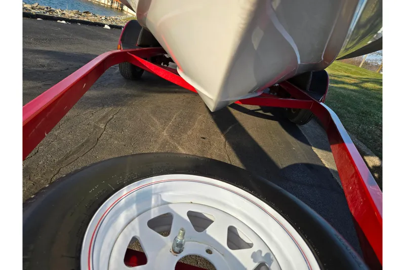 Slide: The Image of 1998 Stratos 290 Ski-N-Fish boat on red trailer, close-up view. - 7