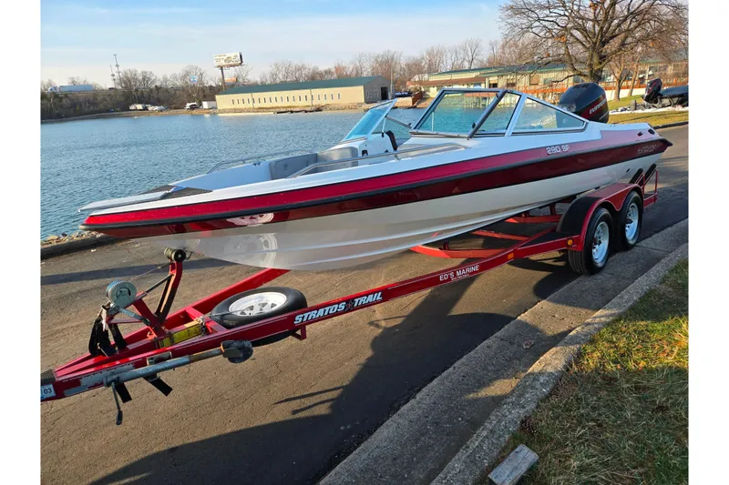 Slide: The Image of 1998 Stratos 290 Ski-N-Fish boat on trailer by a lakeside. - 9