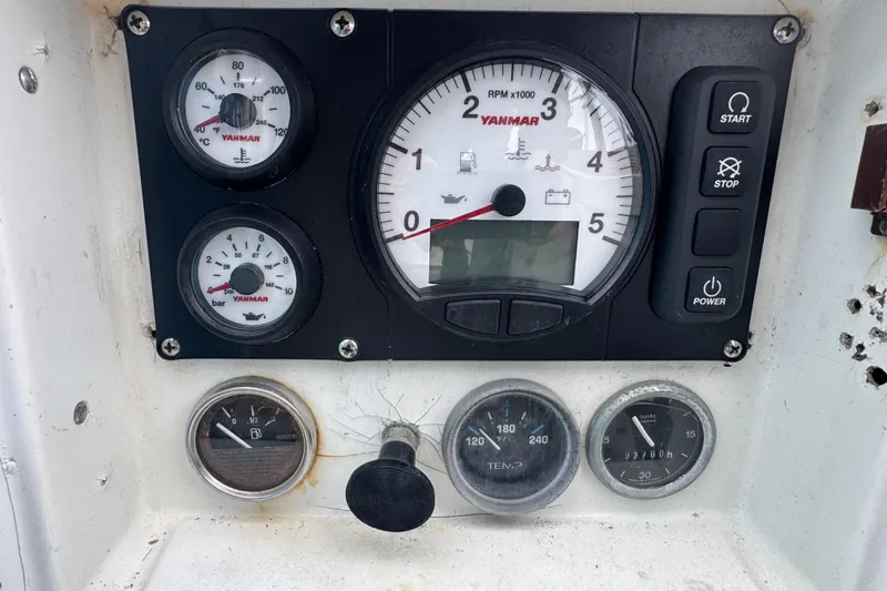 Slide: The Image of Control panel of a 1985 Beneteau First 38 sailboat with Yanmar engine gauges. - 13