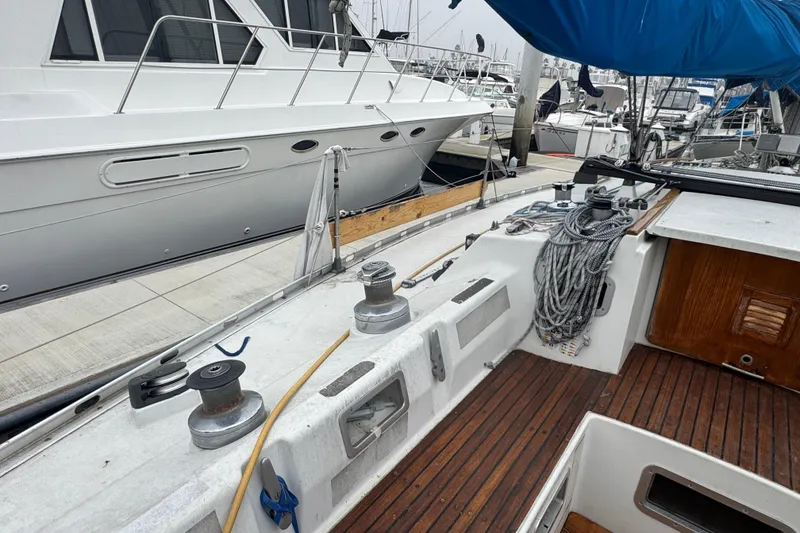 Slide: The Image of Cockpit view of a 1985 Beneteau First 38 sailboat docked at a marina. - 15
