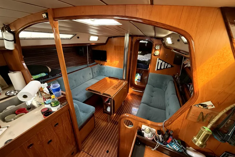 Slide: The Image of Interior of 1985 Beneteau First 38 sailboat with wooden finish and cozy seating area. - 17