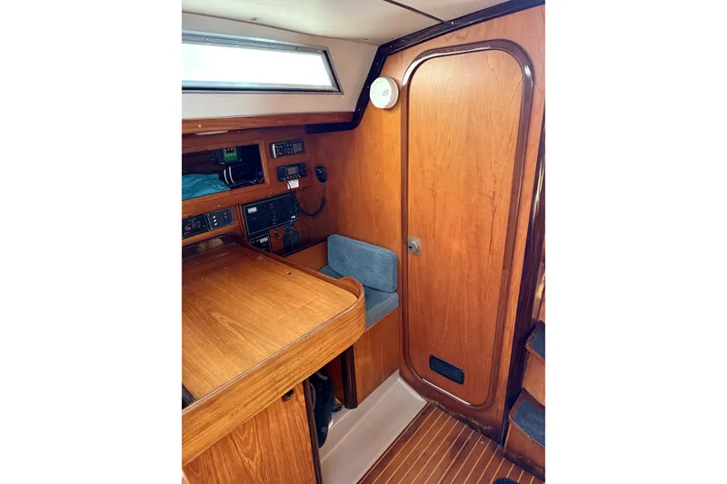 Slide: The Image of Interior of 1985 Beneteau First 38 sailboat with wooden finish and navigation equipment. - 19