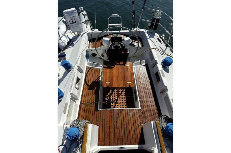 Slide: The Image of Cockpit of 1985 Beneteau First 38 sailboat with wooden deck and steering wheel. - 2