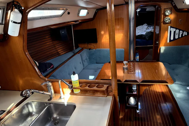 Slide: The Image of Interior of 1985 Beneteau First 38 sailboat with wood finish and cozy seating area. - 20