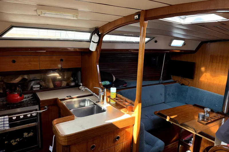 Slide: The Image of Interior of 1985 Beneteau First 38 sailboat with kitchen and seating area. - 21