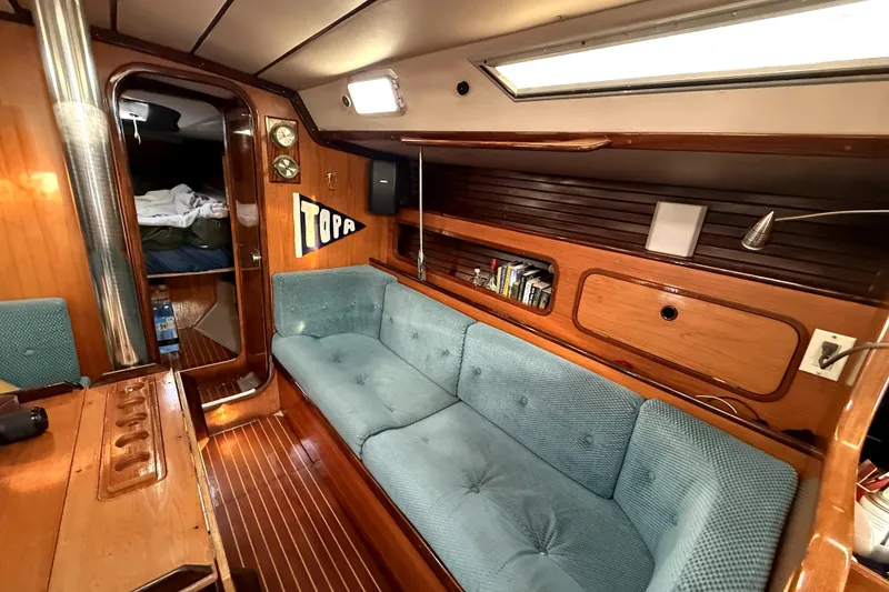 Slide: The Image of Interior of 1985 Beneteau First 38 sailboat with cozy seating and wooden finishes. - 23