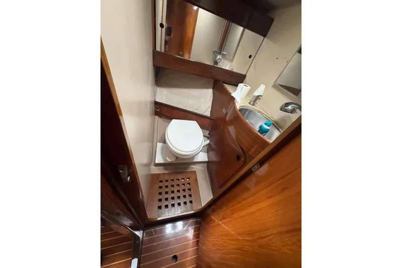 Slide: The Image of 1985 Beneteau First 38 yacht bathroom with wooden cabinetry and compact design. - 26