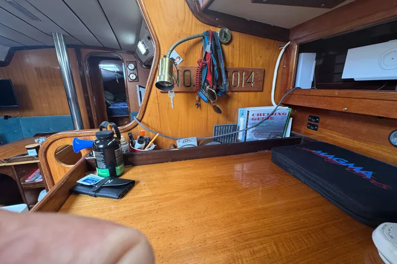 Slide: The Image of Interior of a 1985 Beneteau First 38 sailboat with wooden finish and nautical equipment. - 31