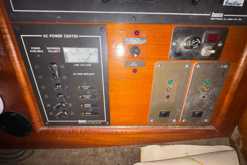 Slide: The Image of Electrical panel of a 1985 Beneteau First 38 sailboat, featuring AC power controls. - 32