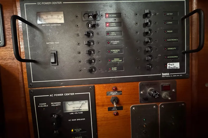 Slide: The Image of Electrical control panel on a 1985 Beneteau First 38 sailboat, featuring DC and AC power centers. - 33